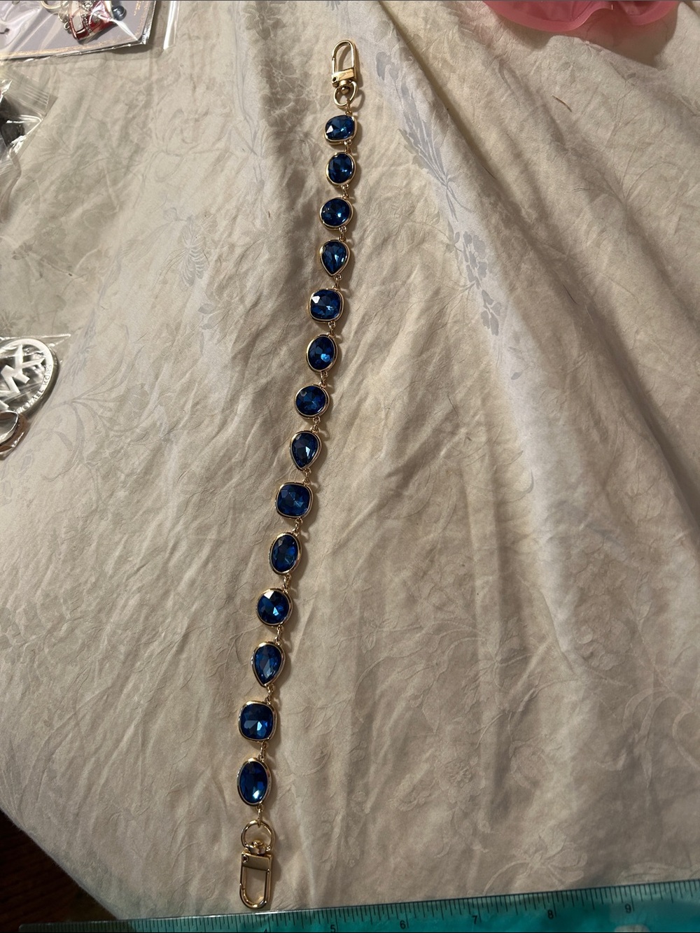 Blue stones in gold tone bag charm